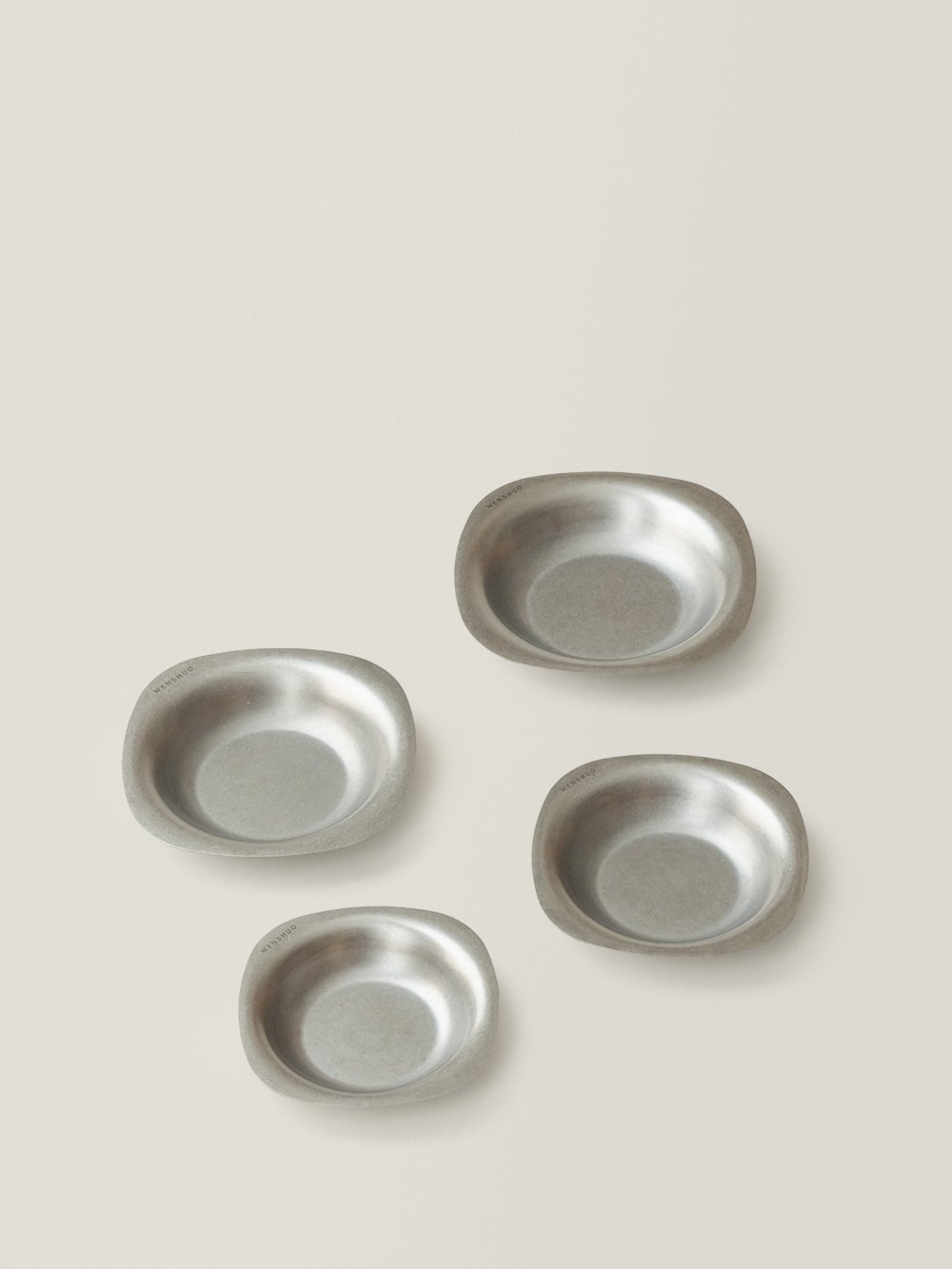 ELOA soft-square stainless steel bowls in four sizes on a warm grey background