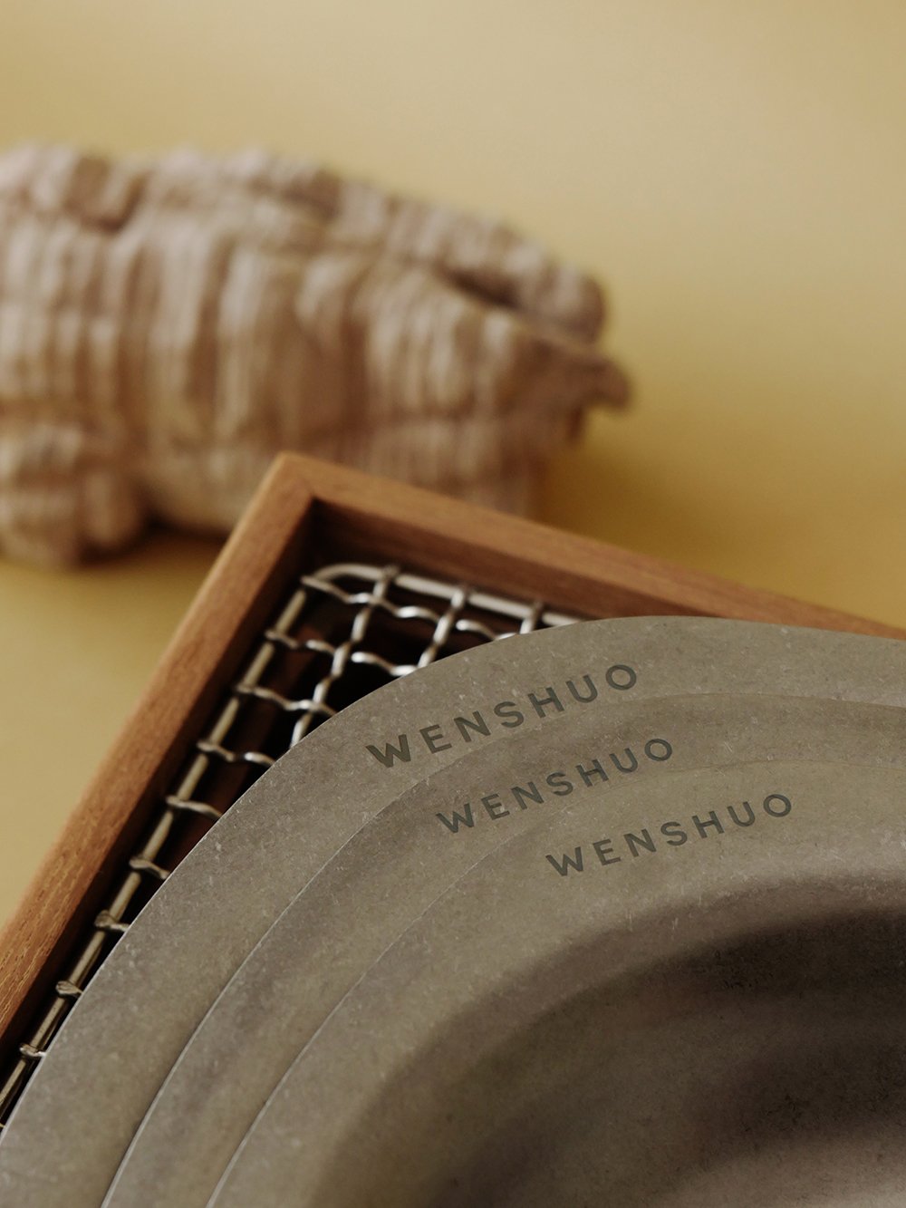 Close-up of stacked ELOA bowls with engraved WENSHUO rims
