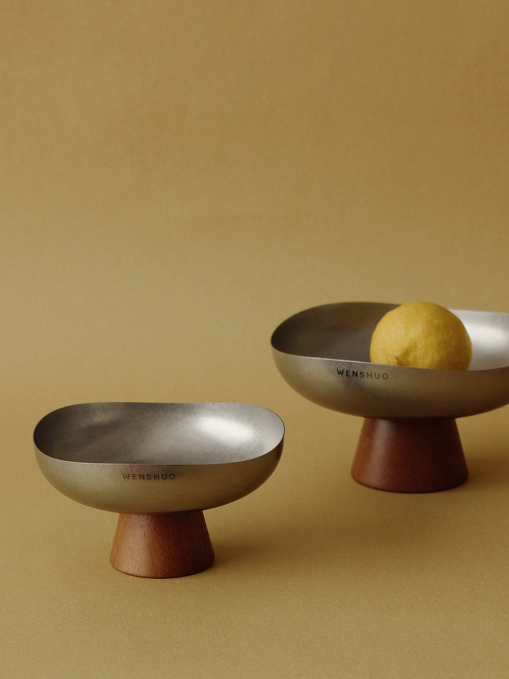 Forma bowls with a lemon on an ochre table